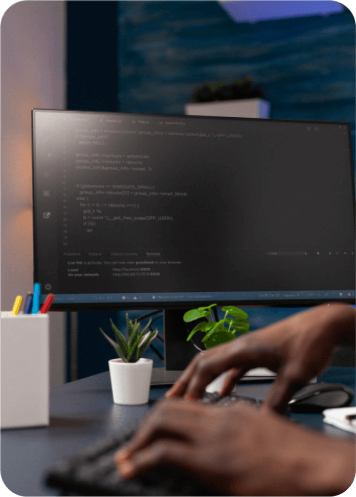 Developer writing code on a desktop computer in a digital web development agency in Malaysia.