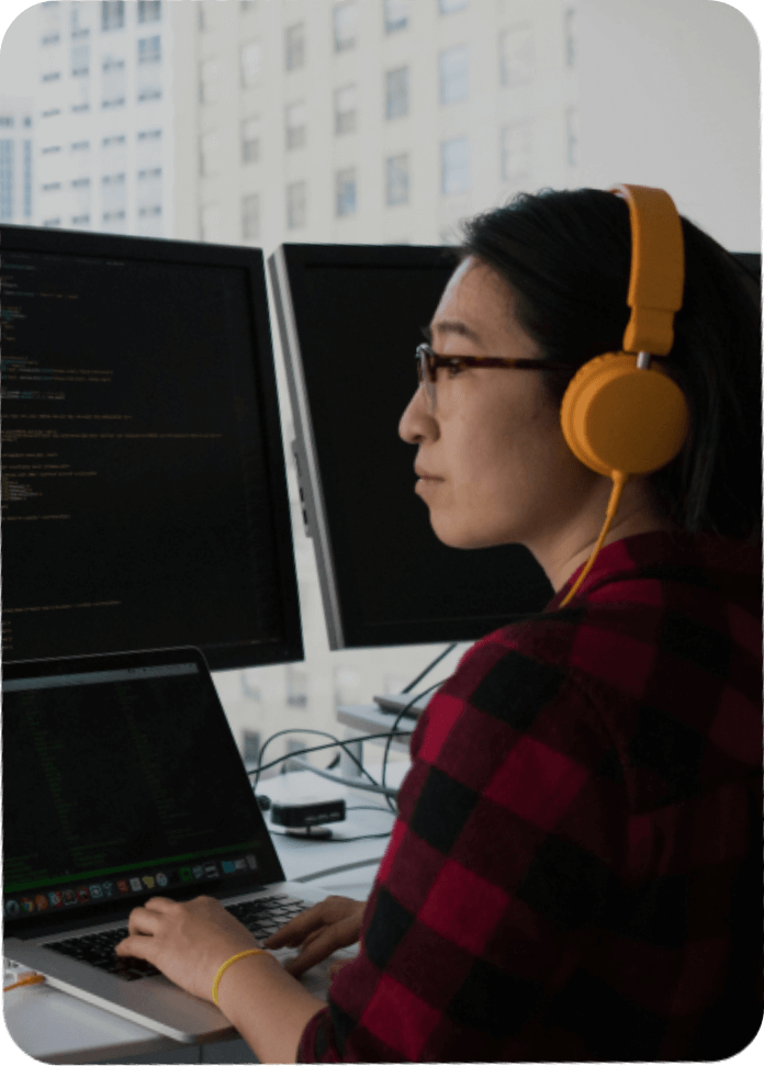 Web developer coding on a laptop in a digital web design and development agency in Malaysia.