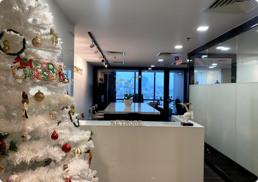 Reception area with Christmas tree and Netmore meeting space in the background, showing a vibrant and collaborative career culture in Malaysia.