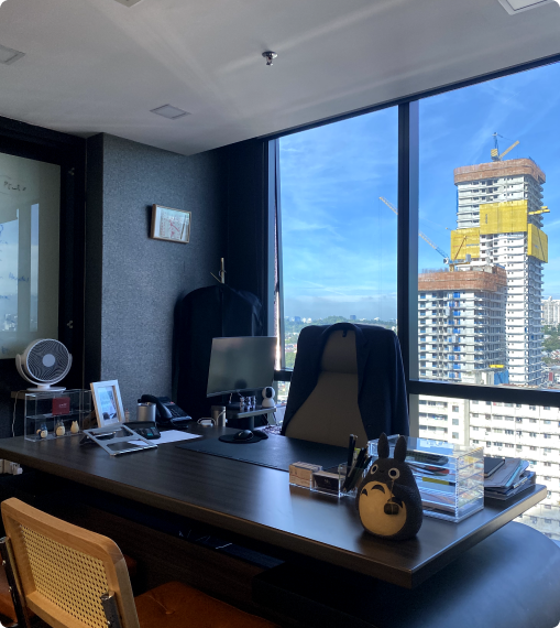 Executive office desk overlooking Kuala Lumpur skyline, reflecting professional and ambitious career opportunities at Netmore.