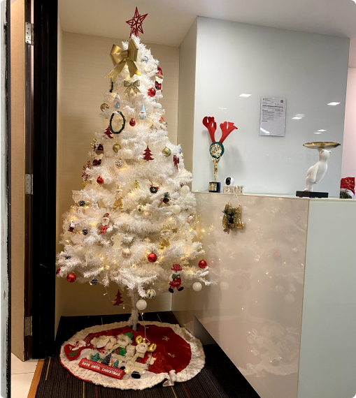White Christmas tree with festive decorations in Netmore office symbolizing teamwork and joyful career culture in Malaysia.