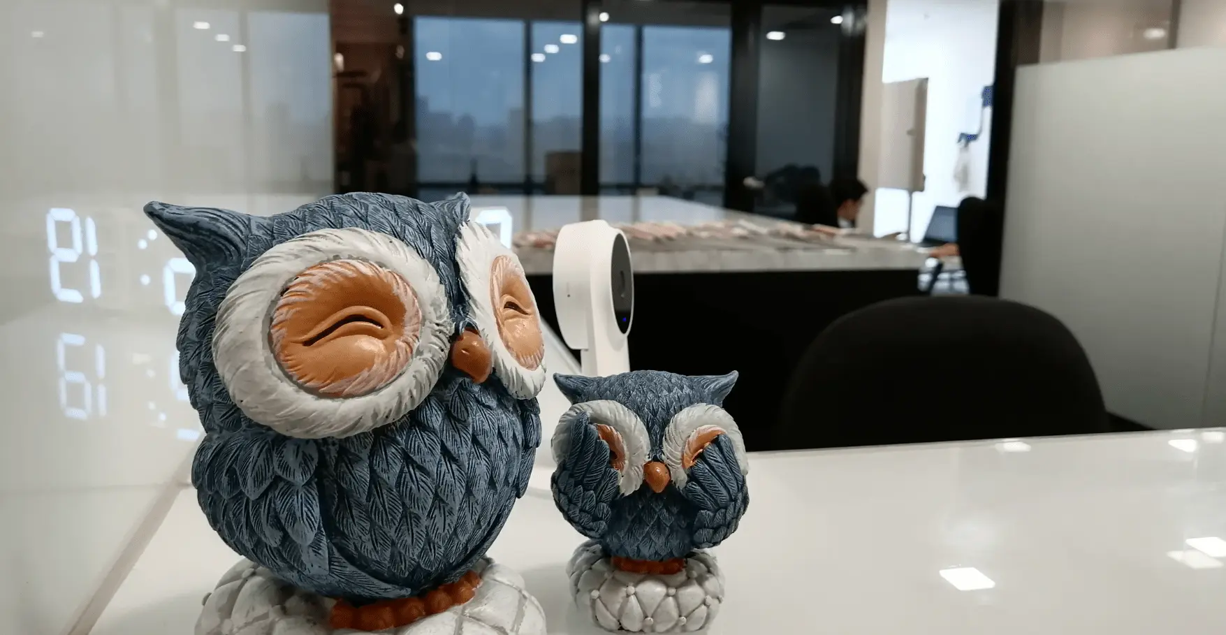 Decorative owl figures on Netmore office desk representing creativity and friendly career culture in Malaysia.