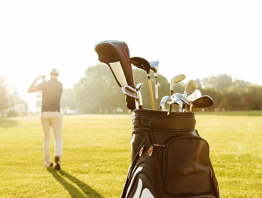 Golf clubs and player on course representing ecommerce sports store in Malaysia