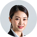 Smiling headshot of a female business executive wearing a blazer, suitable for a corporate leadership profile.