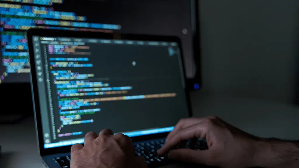 Developer coding on laptop screen – professional web development company Malaysia.